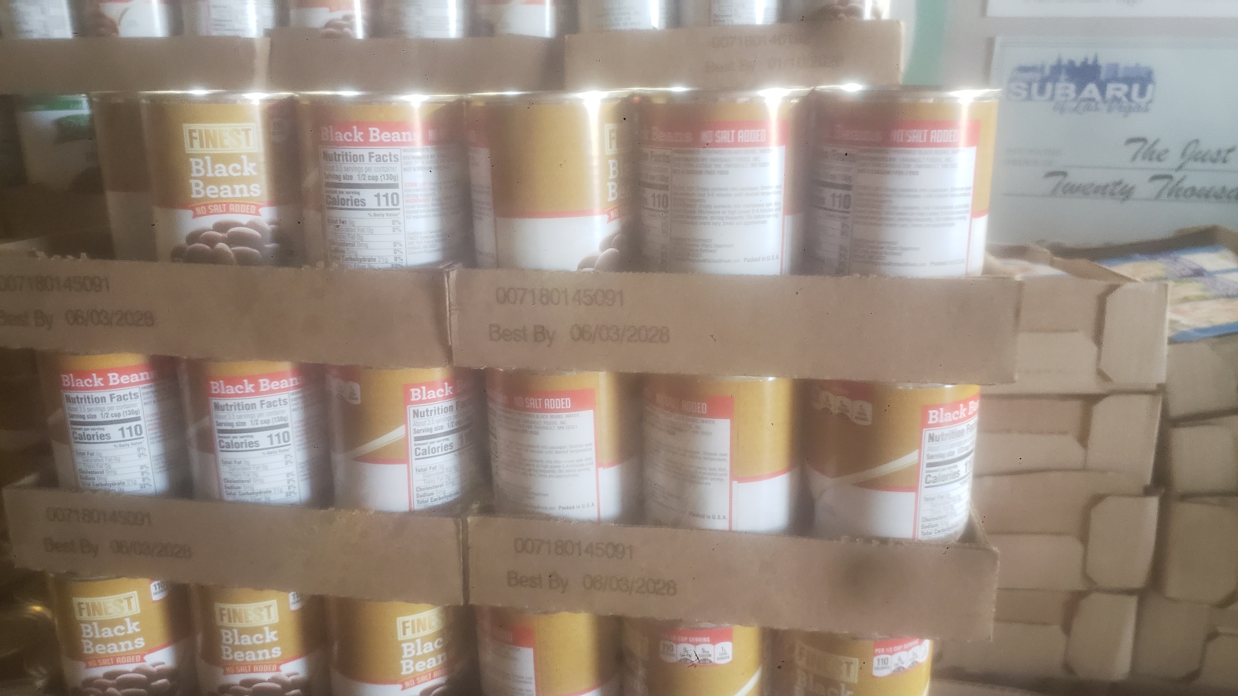 Cardboard trays of canned black beans.